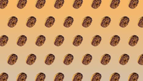 abstracta animación colorida - vista lateral rosquillas con chocolate y caramelo se mueven hacia el lado en fondo de gradiente amarillo - bucle sin costuras.