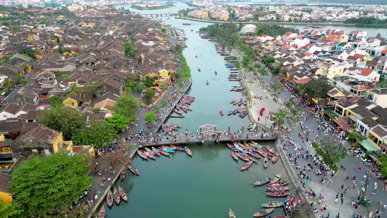 Aerial drone tilt-down shot of An Hoi bridge in Hoi An ancients town in Vietnam. UNESCO world heritage city at Quang Nam province.