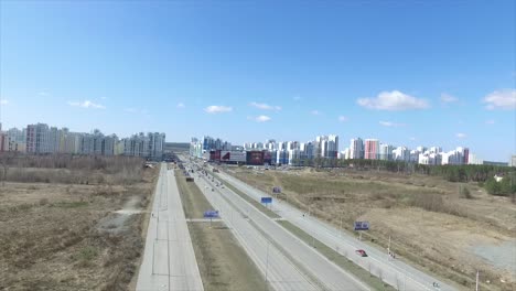 aerial view of suburban city with highway and shopping mall