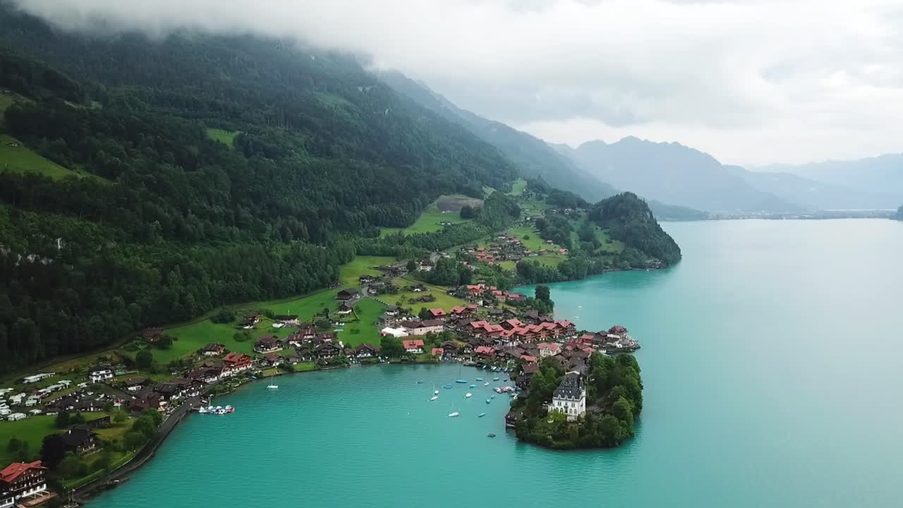 Drone footage of the stunning Iseltwald, with views to the town and the Castle in the Bernese Highland region, in Switzerland.