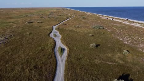 drone approaching vadu beach, passing over the plains and grasslands at the beachfront facing the black sea, located in constanta county, in romania