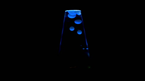 Closeup-of-blue-lit-lava-lamp,-centered-in-frame