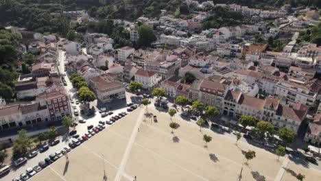 Aerial-flying-above-the-spires-of-Alcobaça-monastery-overlooking-at-the-cityscape-Portugal