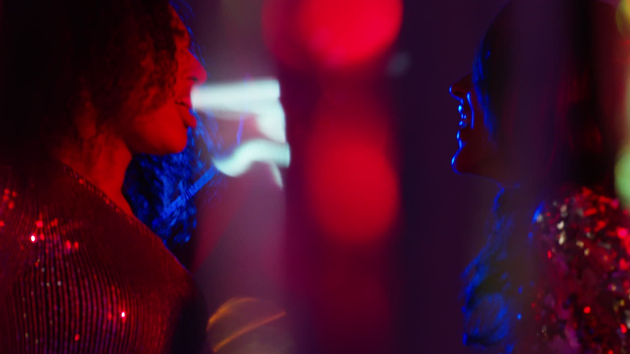 Close Up Of Two Women In Nightclub Bar Or Disco Dancing With Sparkling Lights 11