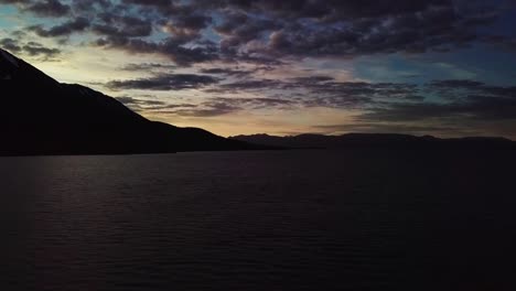 low aerial sweep over dezadeash lake at dusk in yukon, canada