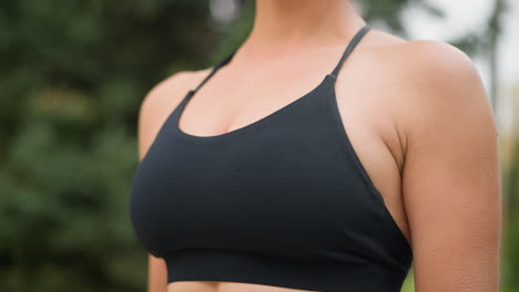 Close-up view of athlete chest area, showing breathing in and out during physical activity, emphasizing fitness and strength, with focus on the top and torso area while wearing sports attire