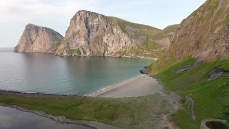 aerial shot of remote lofoten sandvika beach in noway surrounded by steep cliffs