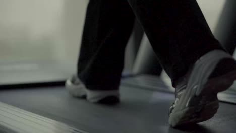 female sneakers walking on treadmill in gym