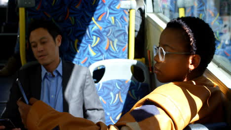 Female-commuter-using-mobile-phone-while-travelling-in-bus-4k