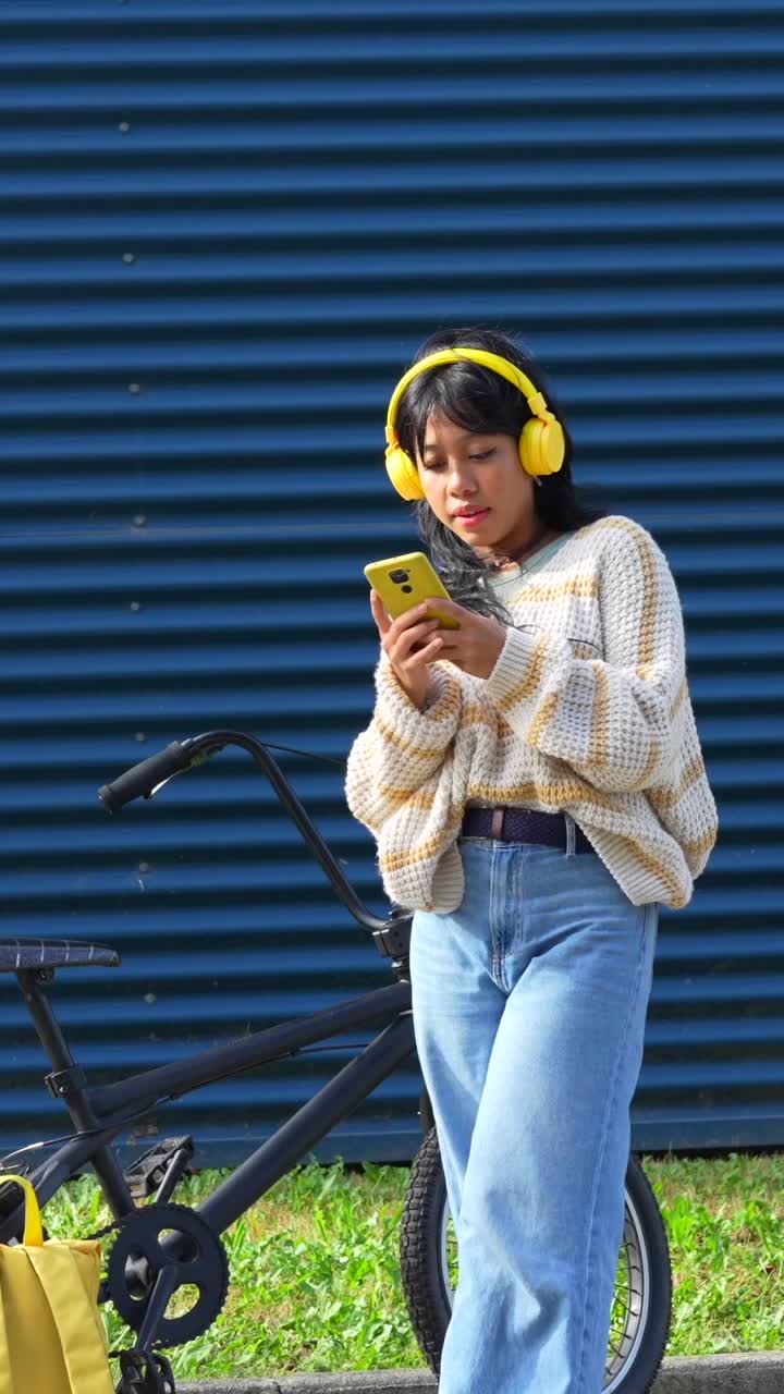 Woman with Yellow Headphones and Bicycle