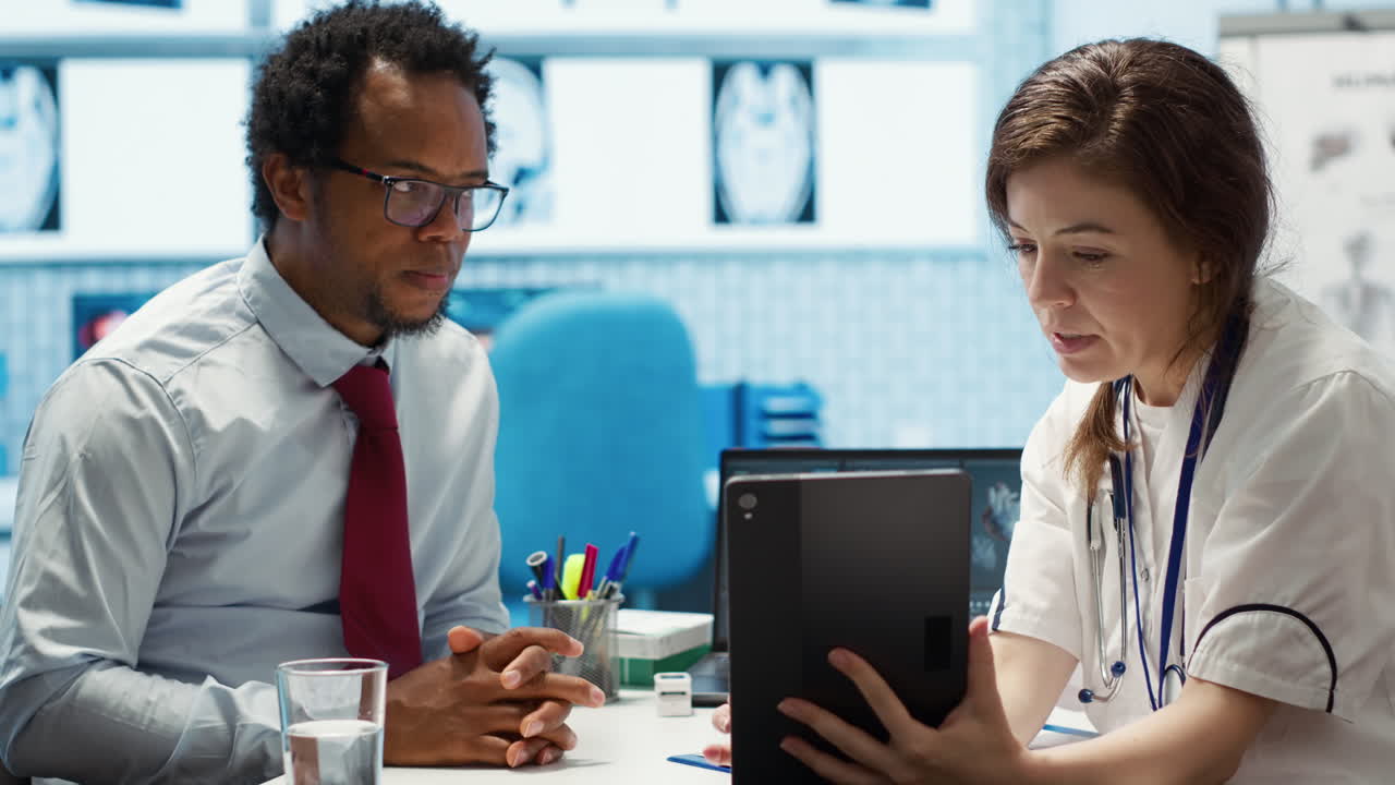 General practitioner presenting the test findings via scan interpretation on tablet