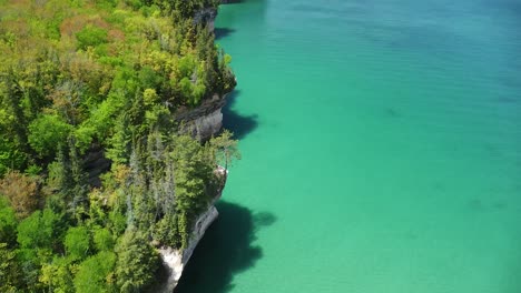 aerial pan up of lakeshore rock cliffs - pictured rocks national lakeshore, michigan