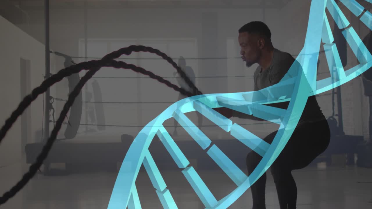 Man gripping ropes and slamming in gym for training, teal blocks forming DNA helix over subject