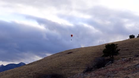 para glider flying over boulder, colorado