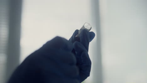 Nurse-hands-preparing-vaccine-dose-for-injection-closeup.-Doctor-filling-syringe