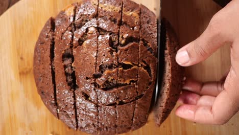 cutting a sliced chocolate cake