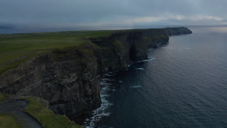 High-angle-view-of-panoramic-tourist-route-on-edge-of-rocks-with-amazing-view-on-high-rocky-cliffs-above-sea-surface.-Natural-scenery-at-sunset.-Cliffs-of-Moher,-Ireland