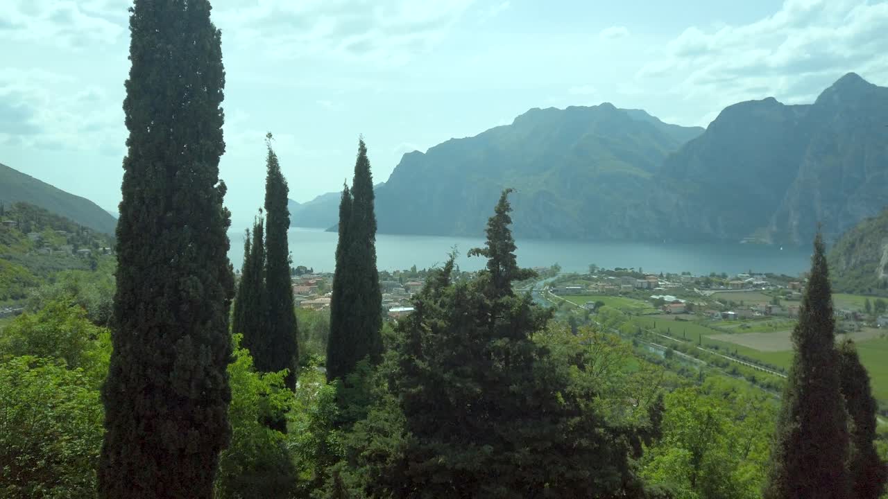 Panoramic view of Lake Garda nature, trees, trekking, green grass, rocks, northern Italian mountains