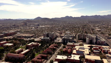 tucson arizona university drone orbit shot with mountains and cityscape