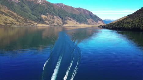 aerial flyover jet boat in lake taylor new nz, jet boating - dolly in shot