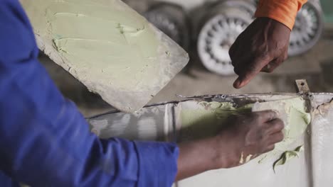 african man painting a car