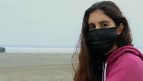 portrait of girl at the beach with face mask