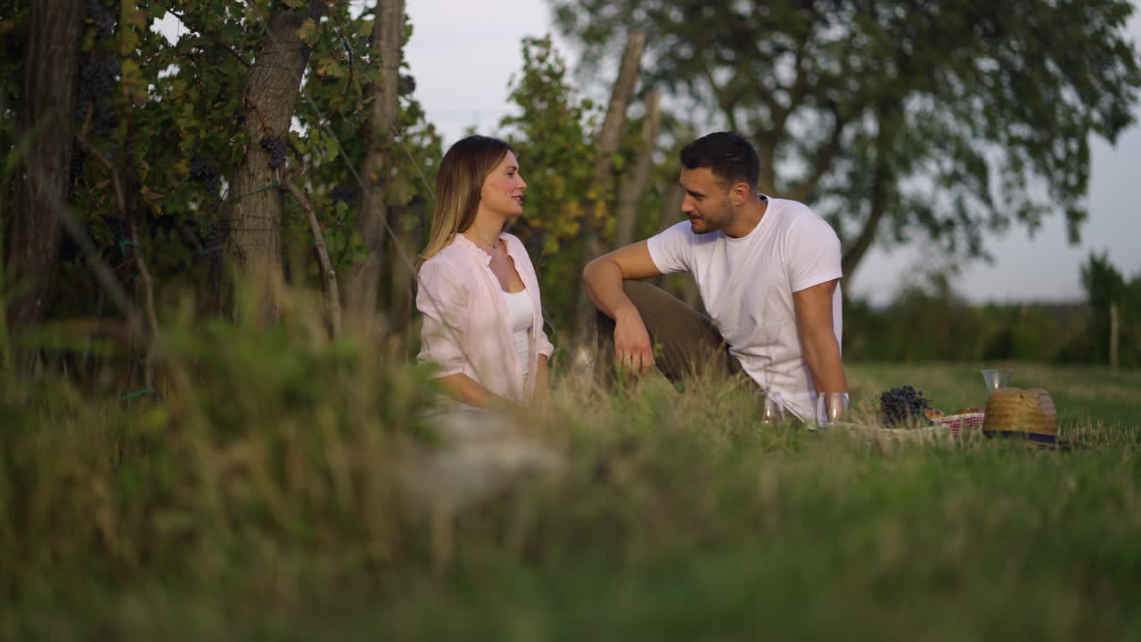 Couple Enjoying a Picnic in a Vineyard