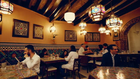 traditional moroccan tea pouring in an ornate cafe setting