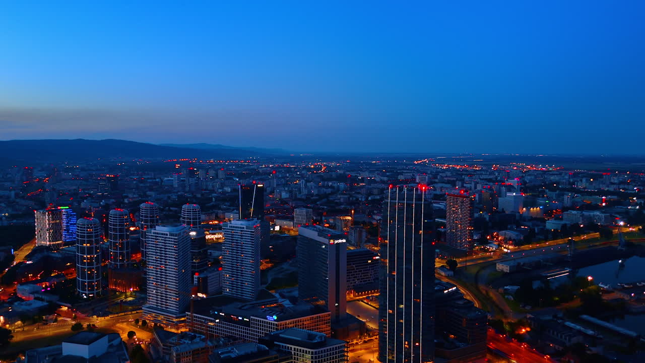 Red light flash on the tops of the high-rises at dusk time. Panorama of Bratislava, Slovakia from top view