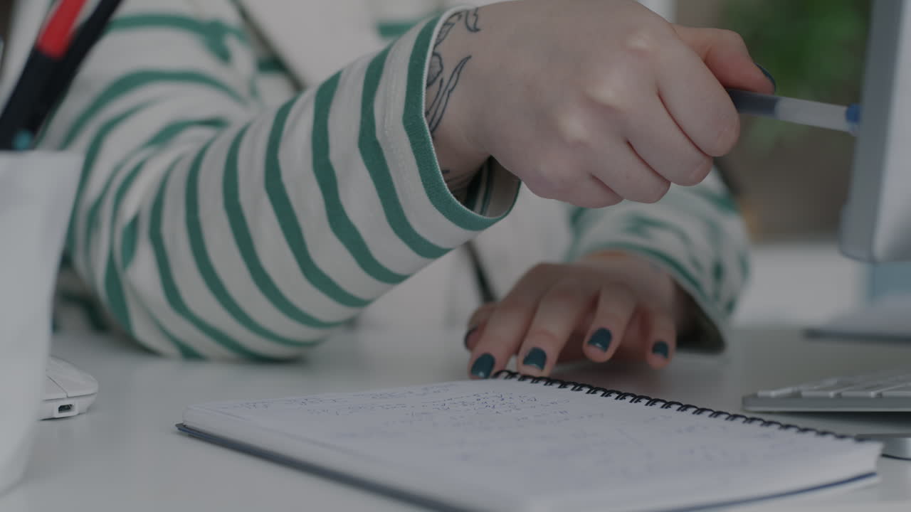 Woman taking notes at her desk