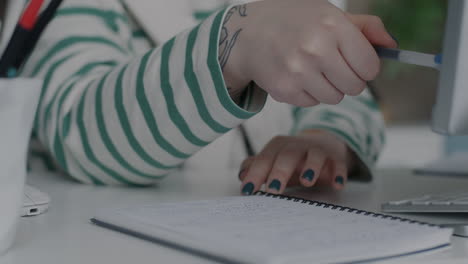 woman taking notes at her desk