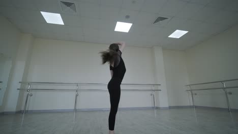 young ballet girl at studio lesson. training performance. stretching exercise pose. ballerina practice balance technique. classical elegance fitness.