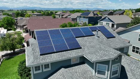 solar panels on colorado home with rocky mountains in background