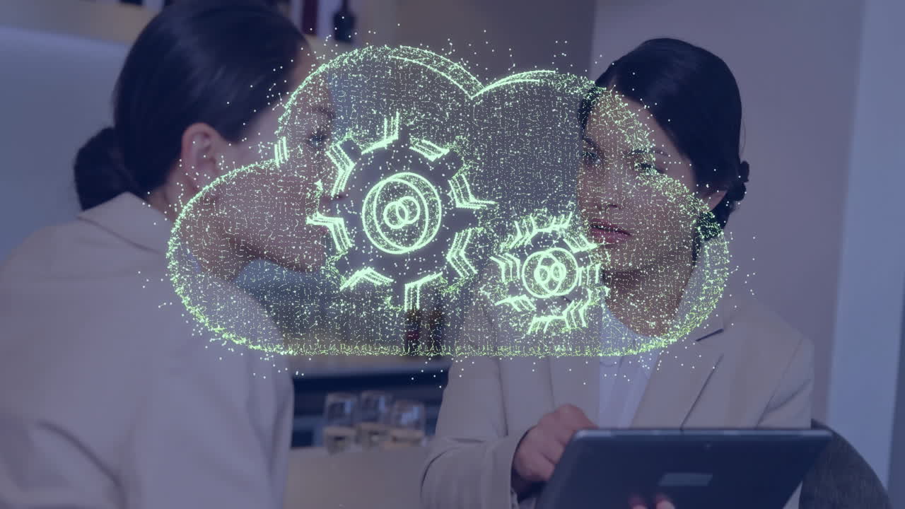 Two professionals discussing technology with cloud and gears animation overlay