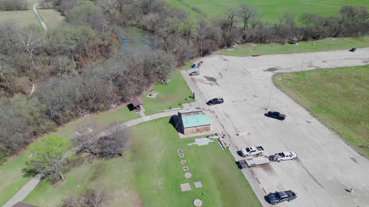 Aerial video of Greenbelt 428 Park at Greenbelt Trail, Aubrey, TX 76227. Drone flies over parking lot.