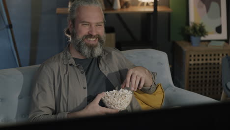 man watching movie with popcorn