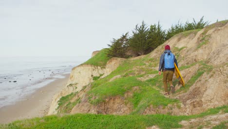 a surfer runs for the beach following a long hike to a remote surf spot