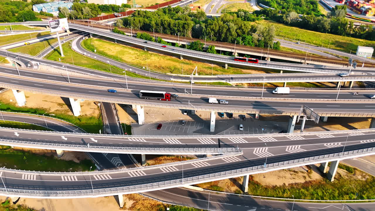 Intricate highway junction in Europe. Aerial view of a complex highway interchange in Europe showcasing multiple lanes and surrounding greenery