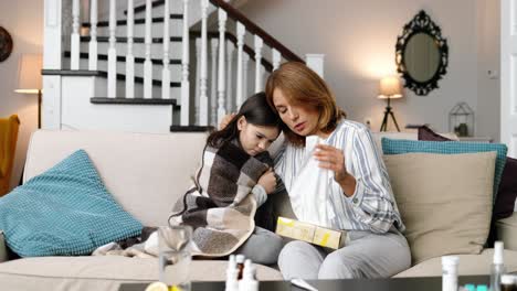 sick little girl at home with her mother