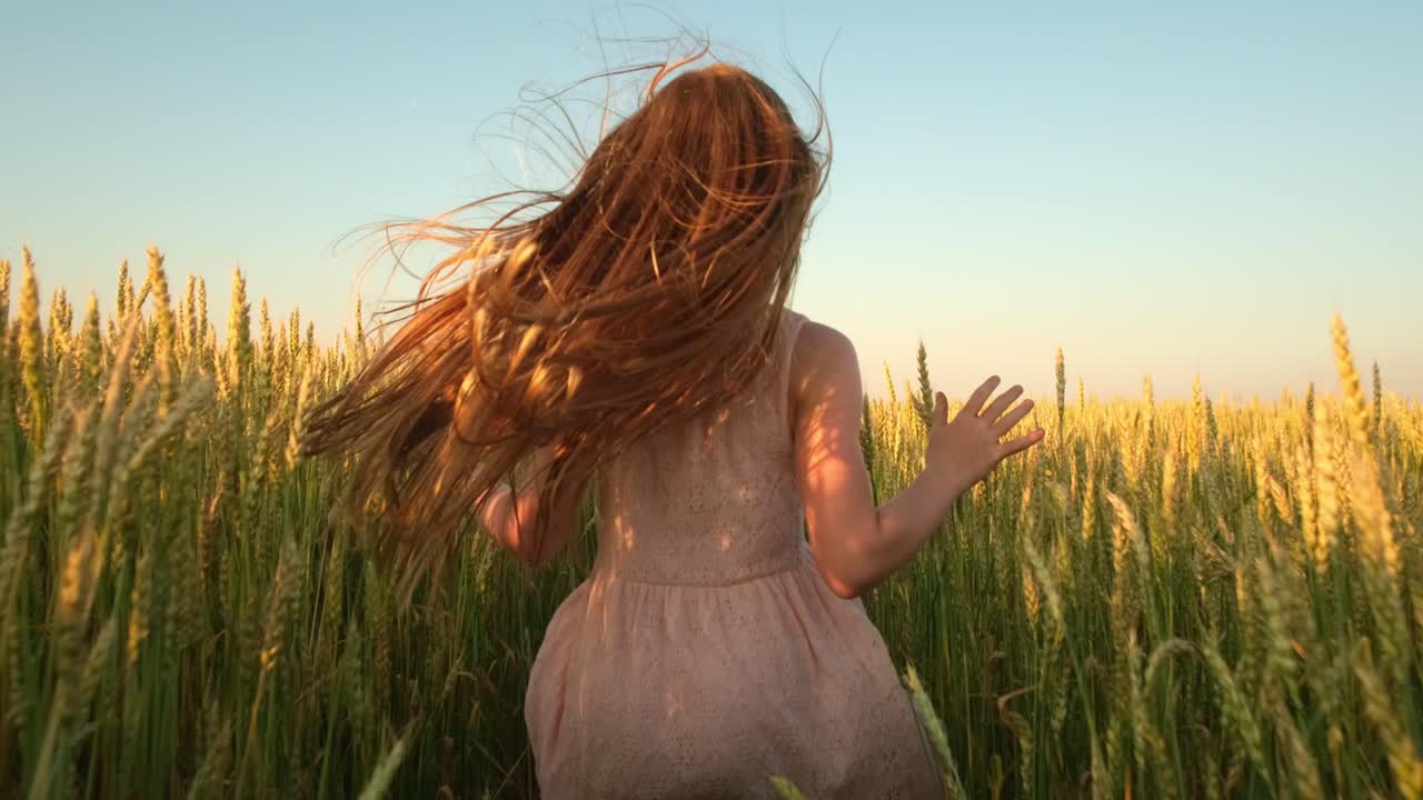Girl Running Through a Wheat Field at Sunset