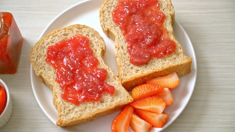 homemade whole wheat bread with strawberry jam and fresh strawberry