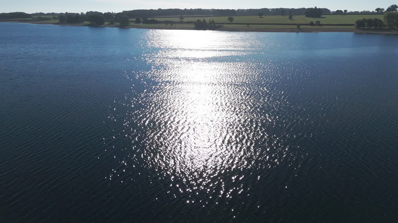 Sun reflection into Rutland water reservoir England Oakham United Kingdom, aerial drone