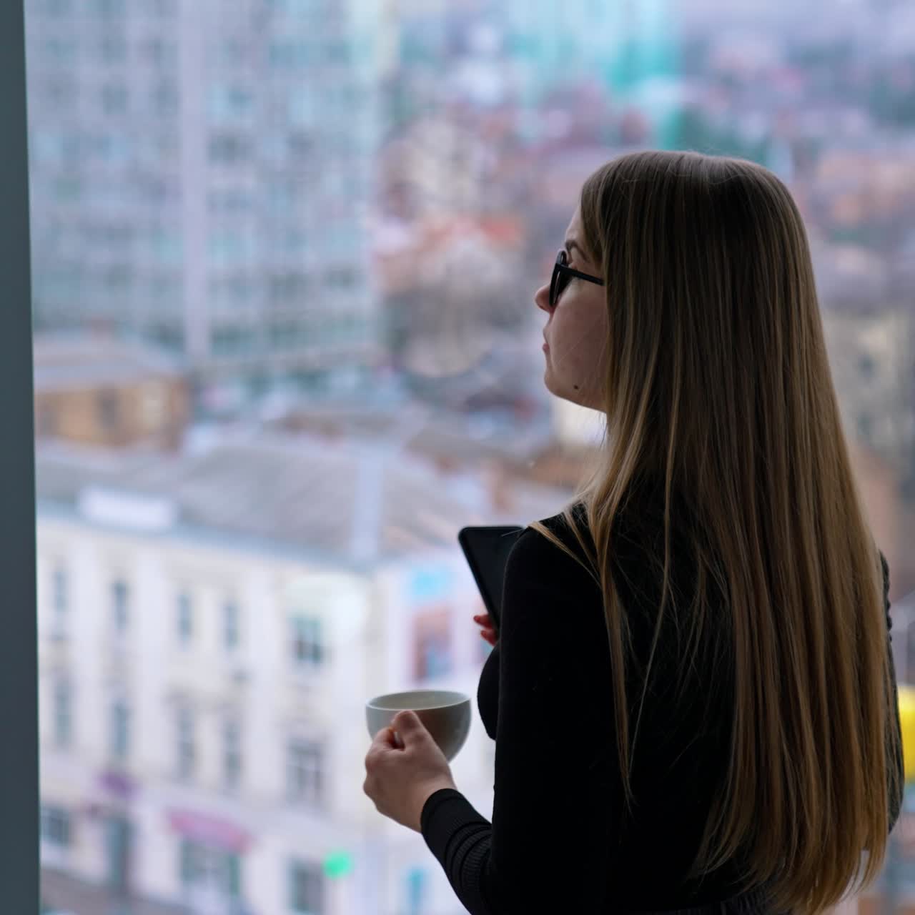 Beautiful woman wearing eyeglasses using cellphone and drinking coffee