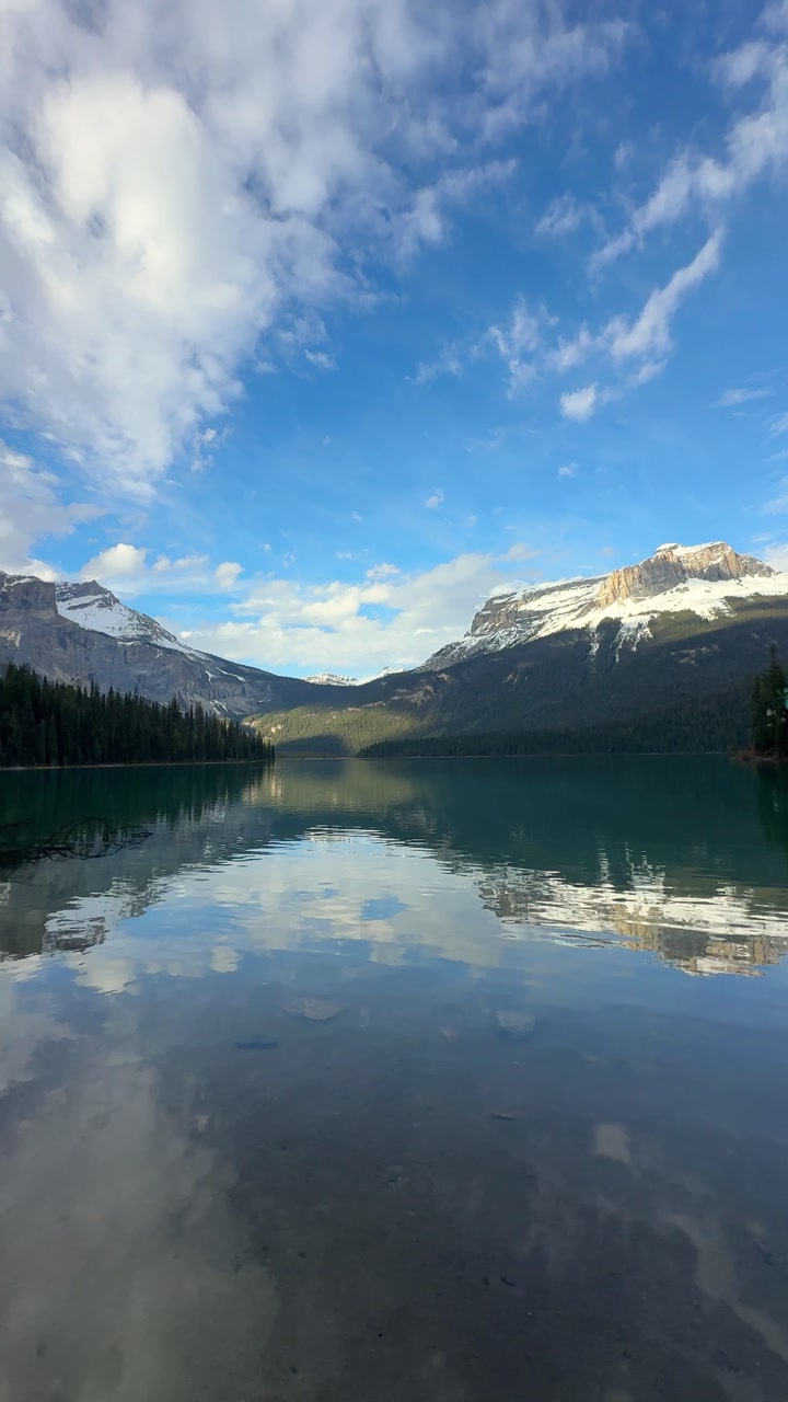 Emerald Lake mirroring Canadian Rockies mountain peak in Yoho National Park