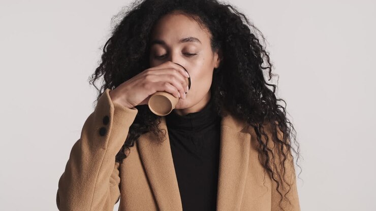 Young businesswoman enjoying cappuccino.