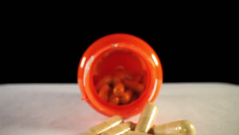 moving past cap, pushing slowly into the opening of an orange supplement pill bottle