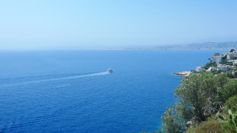 High-angle-view-of-scenic-Nice-shoreline-with-yacht-cruising-in-Mediterranean