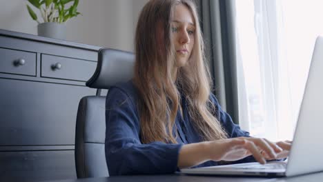 Young-businesswoman-typing-and-working-at-home-office-desk