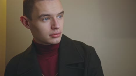 a well-dressed handsome young man staring at the camera - closeup shot