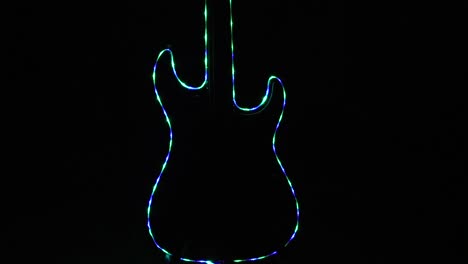 closeup of electric guitar shape with variable colors of multicolored led's